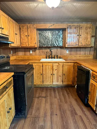 a kitchen with wooden floors and a sink