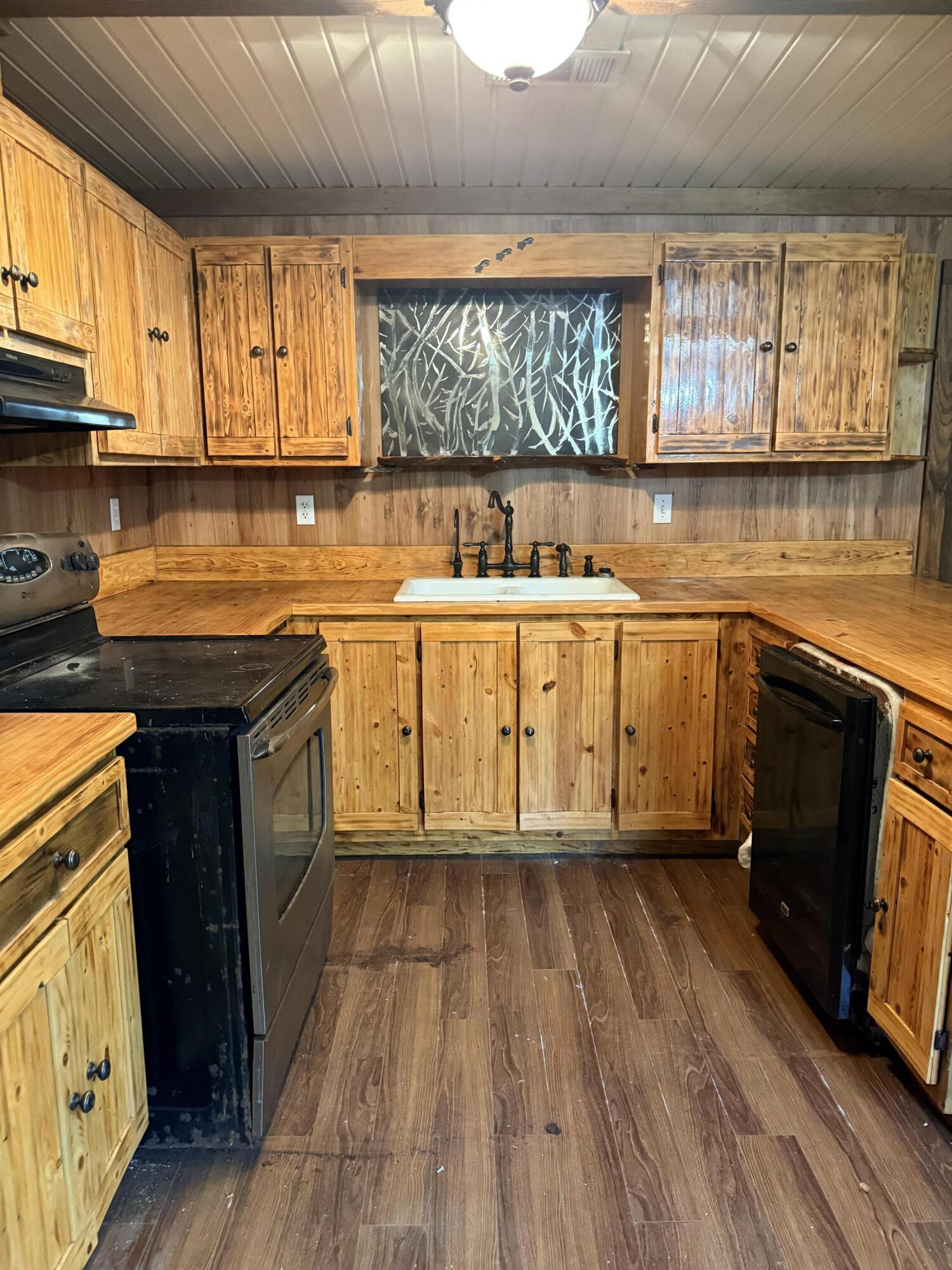 2483 Jordan Road Flomaton, AL 36441 - Photo 7 of 28 a kitchen with wooden floors and a sink