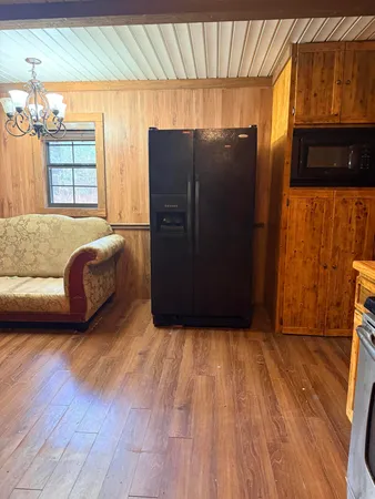 a living room with a couch and a dresser next to a window