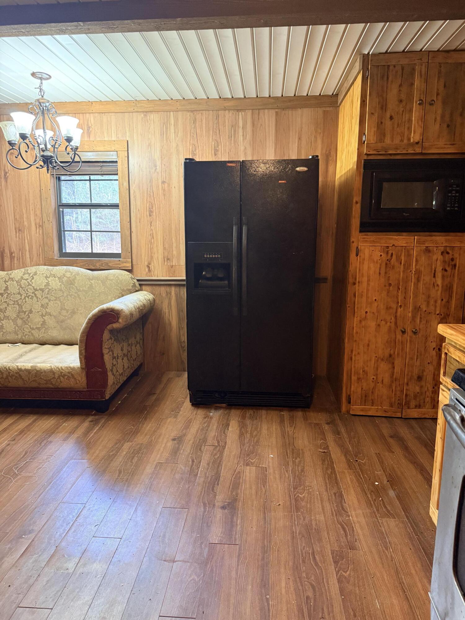 2483 Jordan Road Flomaton, AL 36441 - Photo 10 of 28 a living room with a couch and a dresser next to a window
