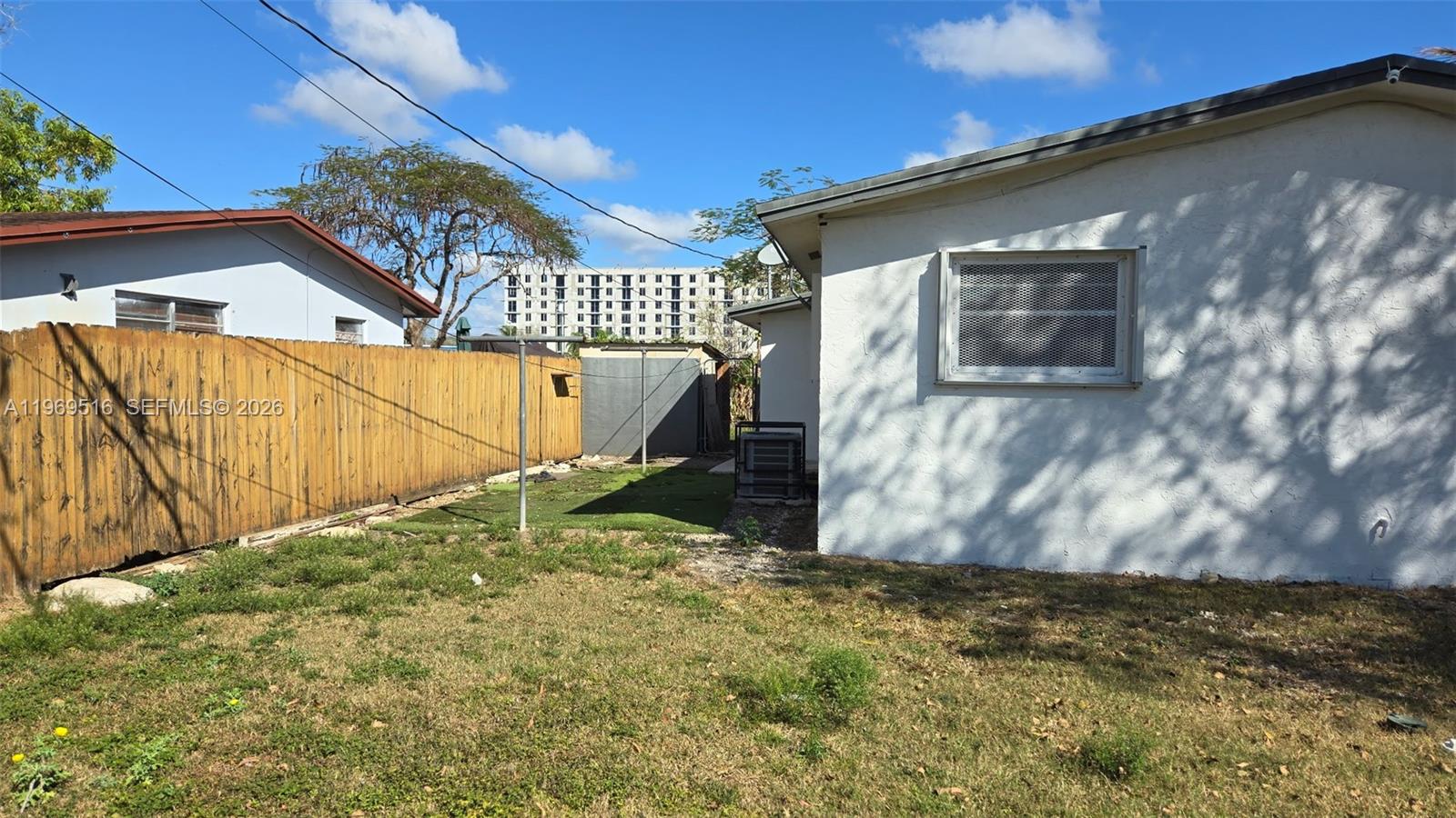 28152 Southwest 153rd Avenue, Unit 28152 Homestead, FL 33033 - Photo 3 of 12 a view of backyard with wooden fence