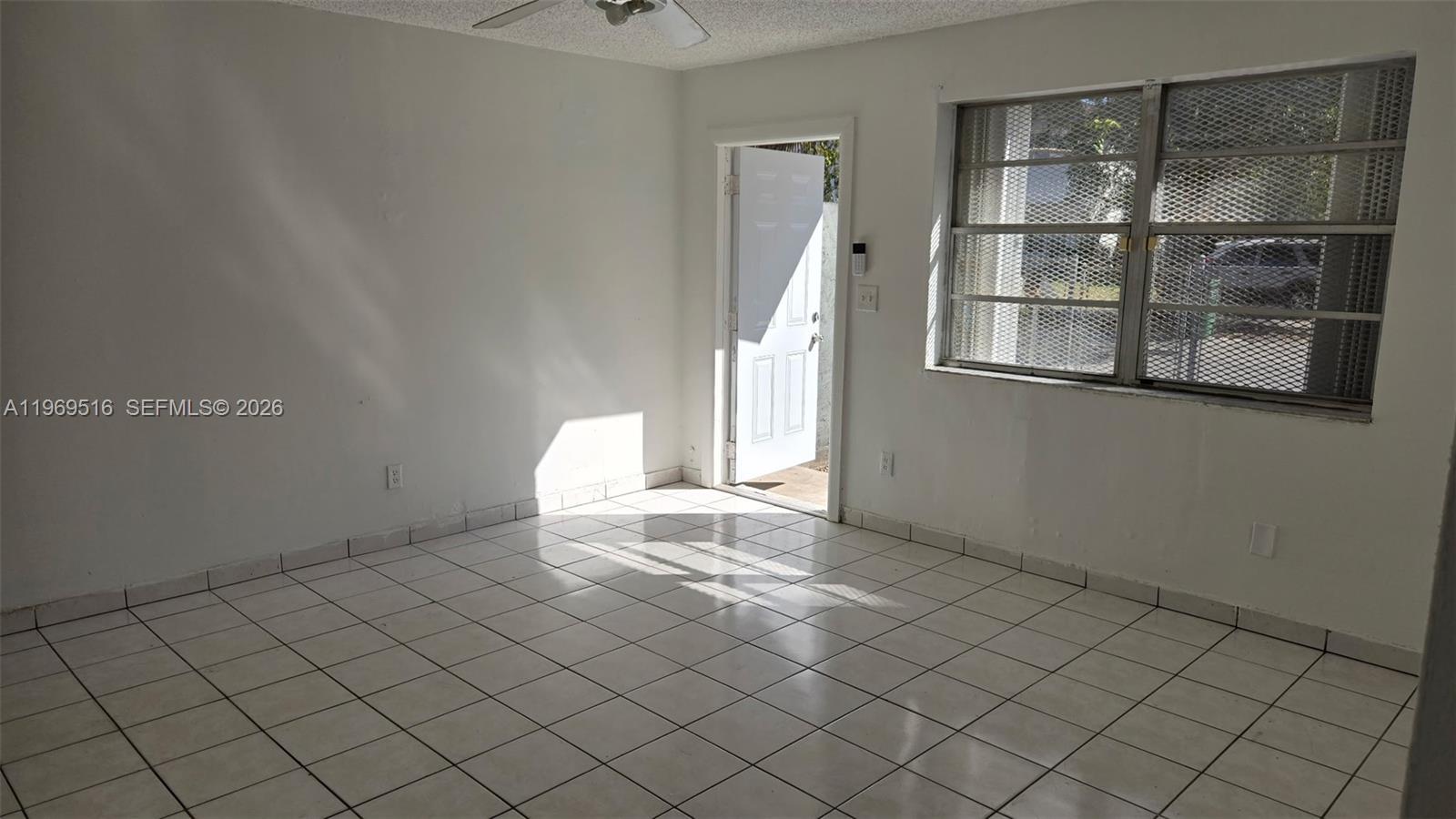 28152 Southwest 153rd Avenue, Unit 28152 Homestead, FL 33033 - Photo 5 of 12 a view of a livingroom with an empty space and a window