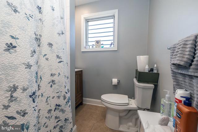 512 Jessamine Avenue Oaklyn, NJ 08107 - Photo 19 of 25 a white toilet sitting next to a shower curtain