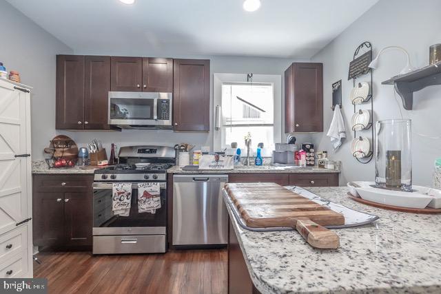 512 Jessamine Avenue Oaklyn, NJ 08107 - Photo 24 of 25 a kitchen with kitchen island granite countertop wooden cabinets and a stove