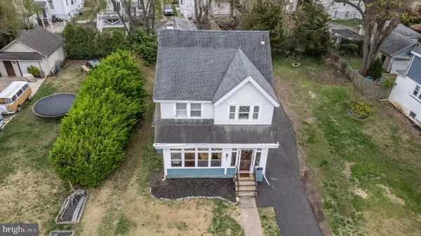 an aerial view of a house with yard and green space