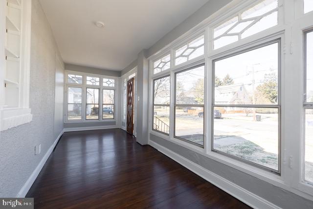 512 Jessamine Avenue Oaklyn, NJ 08107 - Photo 5 of 25 a view of an empty room with wooden floor and a window