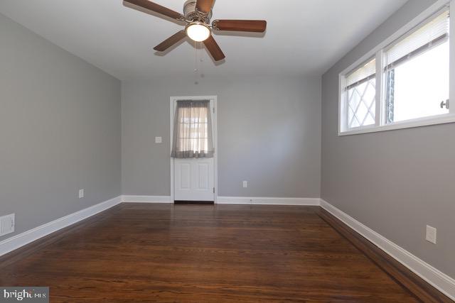 512 Jessamine Avenue Oaklyn, NJ 08107 - Photo 7 of 25 an empty room with wooden floor fan and windows