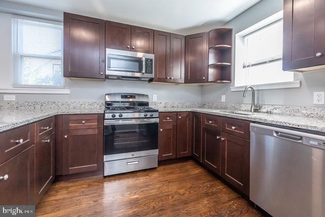 512 Jessamine Avenue Oaklyn, NJ 08107 - Photo 10 of 25 a kitchen with granite countertop stainless steel appliances and cabinets