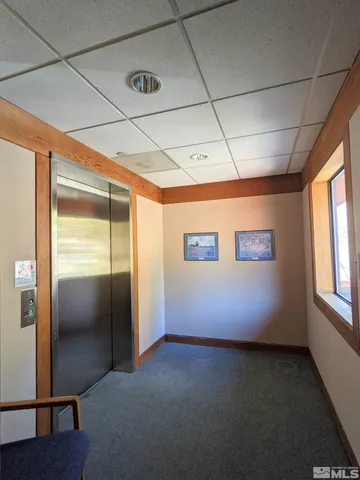 a living room with furniture and a projector screen