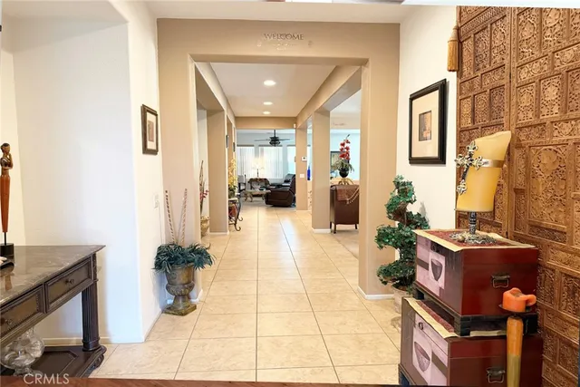 a living room with furniture a large window and a chandelier