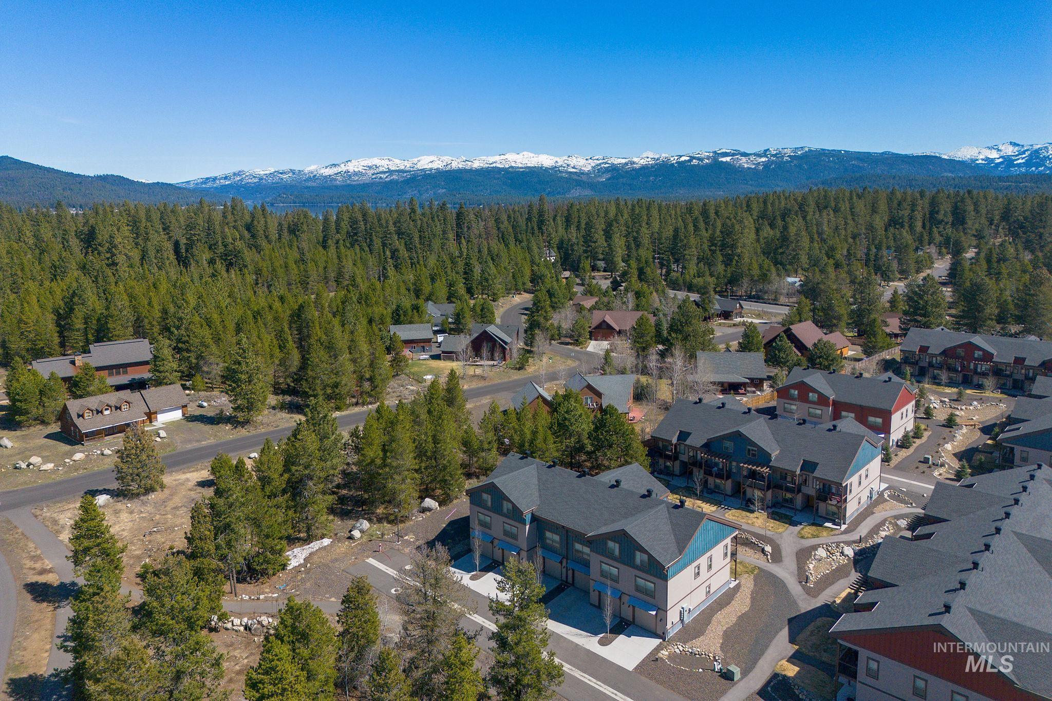 311 Broken Ridge Way McCall, ID 83638 - Photo 33 of 44 Residential community featuring a mix of single-family homes and multi-story buildings, surrounded by dense evergreen forests and paved roadways