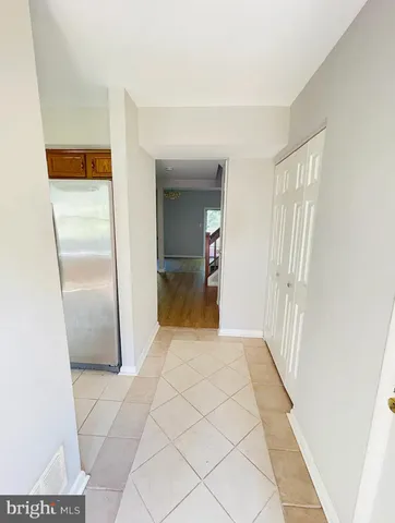 a view of a hallway to rooms and wooden floor