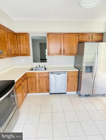 a kitchen with stainless steel appliances a sink and a cabinets