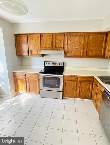 a kitchen with stainless steel appliances a stove a sink and a microwave