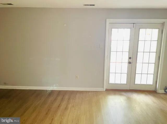 an empty room with wooden floor