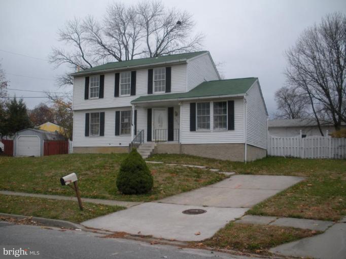 7012 Glen Spring Road Windsor Mill, MD 21244 - Photo 1 of 15 a front view of a house with garden