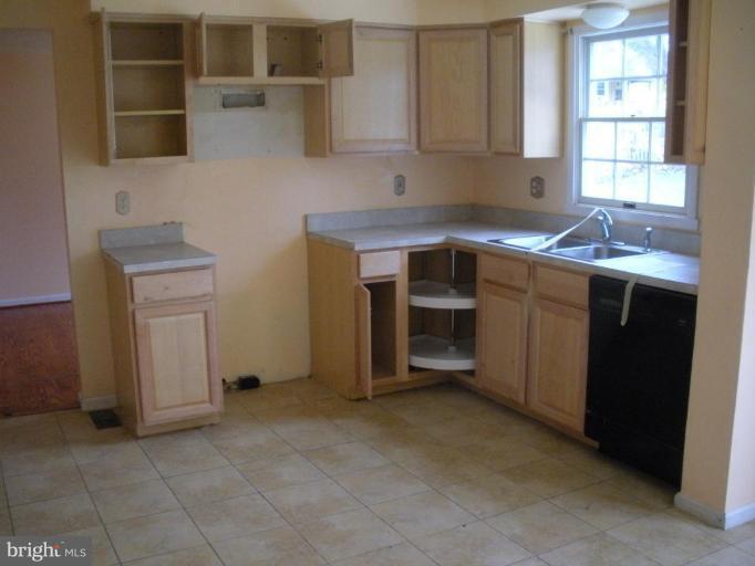 7012 Glen Spring Road Windsor Mill, MD 21244 - Photo 5 of 15 a kitchen with a sink cabinets and a window