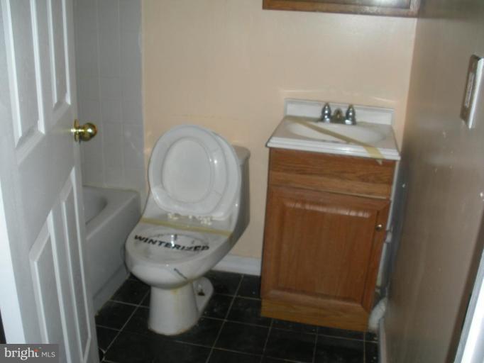 7012 Glen Spring Road Windsor Mill, MD 21244 - Photo 9 of 15 a bathroom with a toilet sink and tub