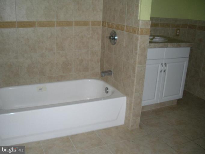 7012 Glen Spring Road Windsor Mill, MD 21244 - Photo 10 of 15 a bathroom with a bathtub and shower