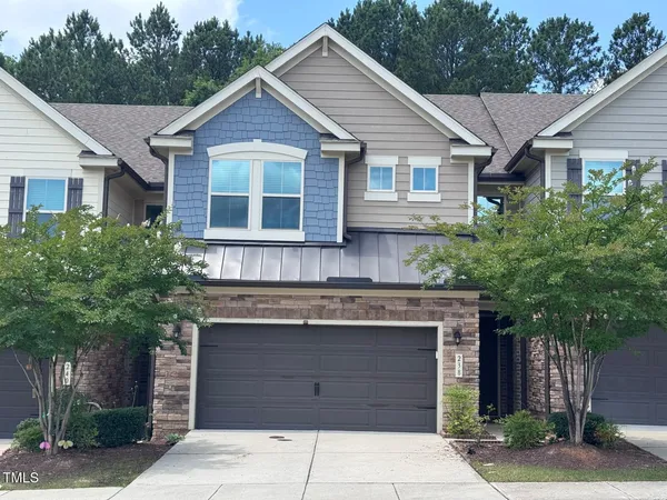 a front view of a house with a garden