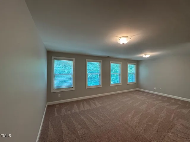 an empty room with a empty space and windows