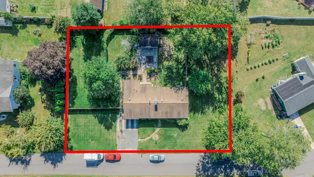 an aerial view of house and swimming pool