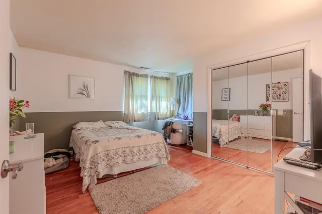 a bedroom with furniture and flat screen tv