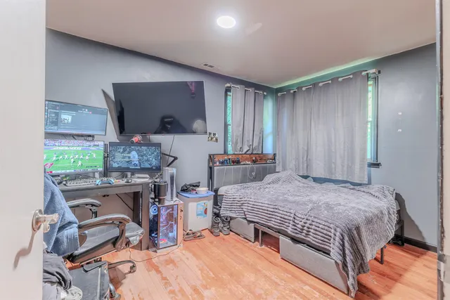 a bedroom with a bed and a window