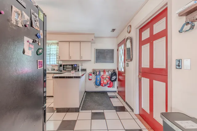 a storage room with a washing machine and racks on the wall