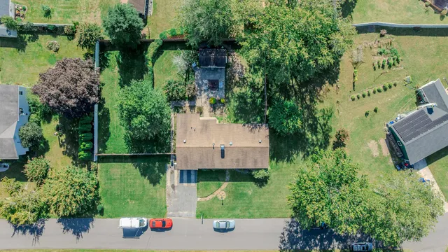 an aerial view of a house with a yard