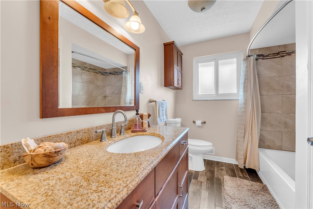 3023 Norris Avenue Cleveland, OH 44134 - Photo 24 of 41 Bathroom featuring a single vanity with a granite countertop, undermount sink, and brushed nickel faucet