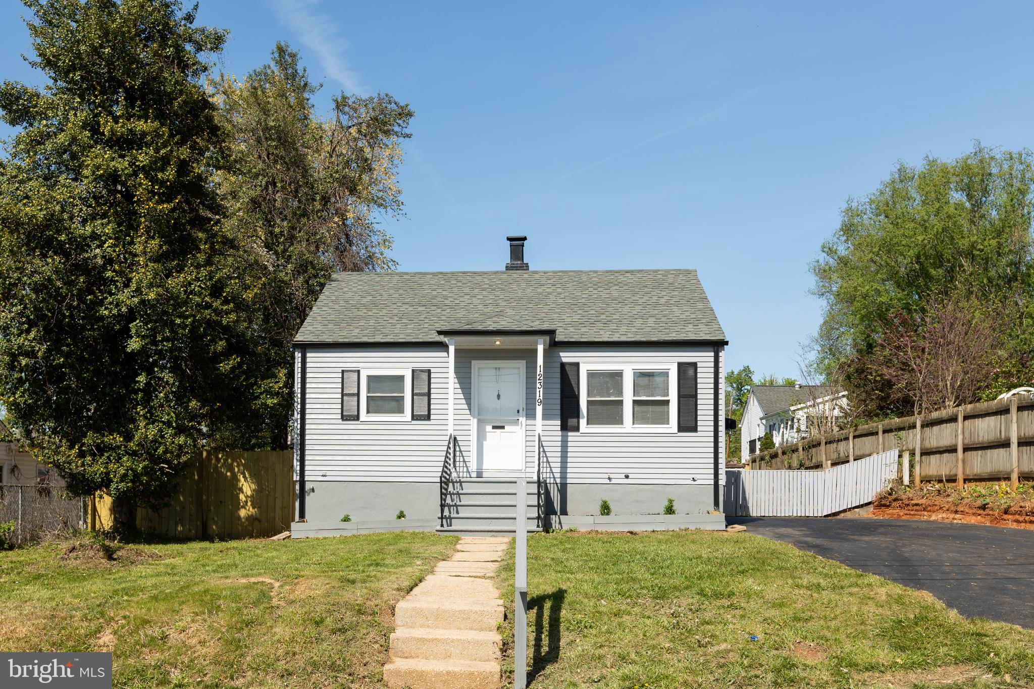 12319 Middle Road Silver Spring, MD 20906 - Photo 2 of 37 a front view of a house with a yard