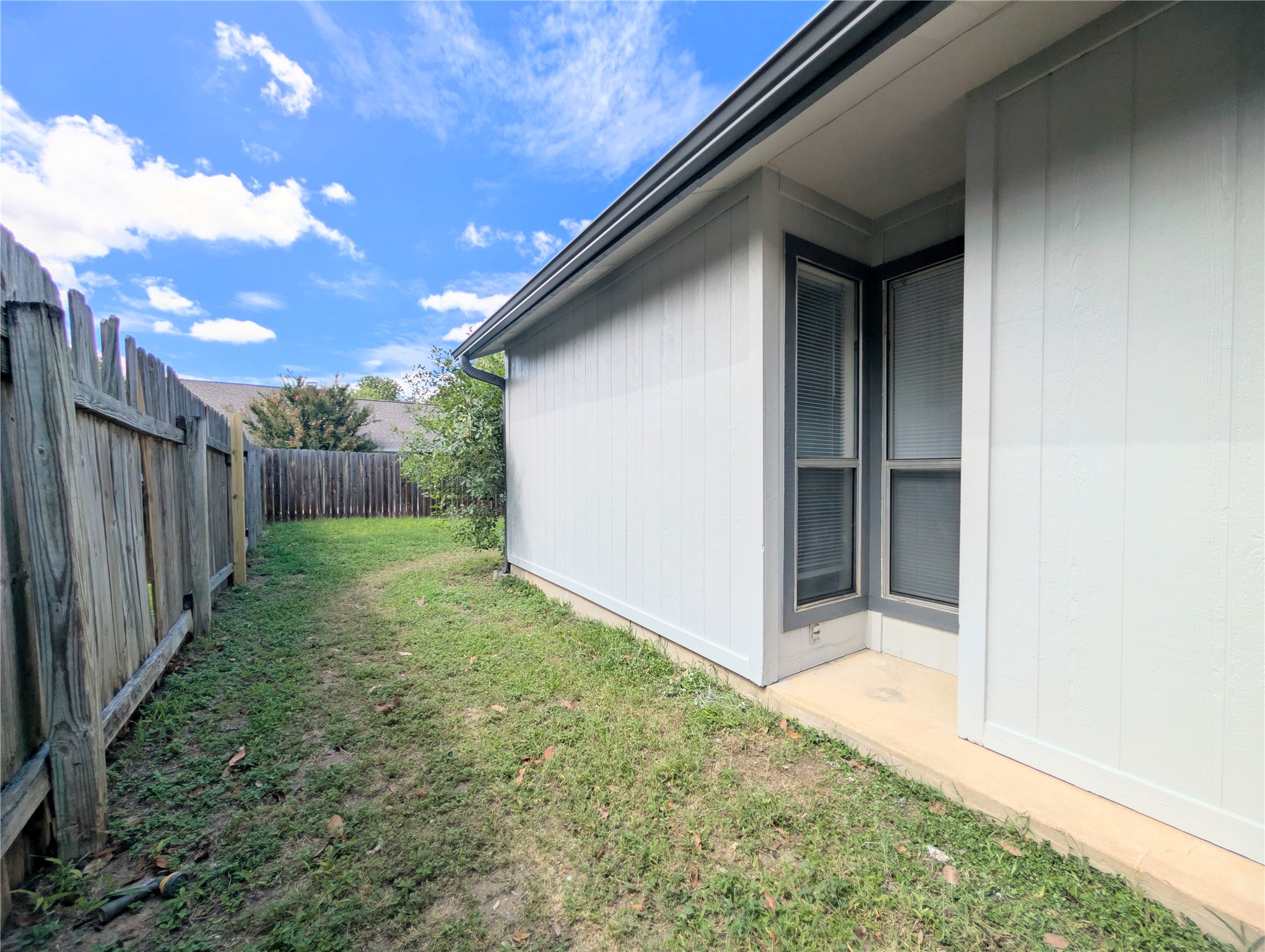 2036 Redwing Way Round Rock, TX 78664 - Photo 6 of 23 A private side yard with a sturdy wooden fence offers a tranquil outdoor retreat.