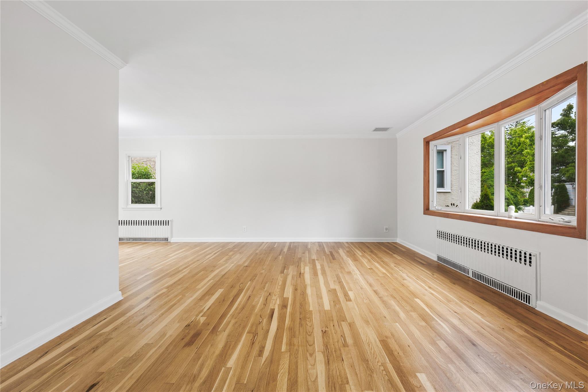 46 Mathews Street Harrison, NY 10528 - Photo 3 of 30 wooden floor in an empty room with a window