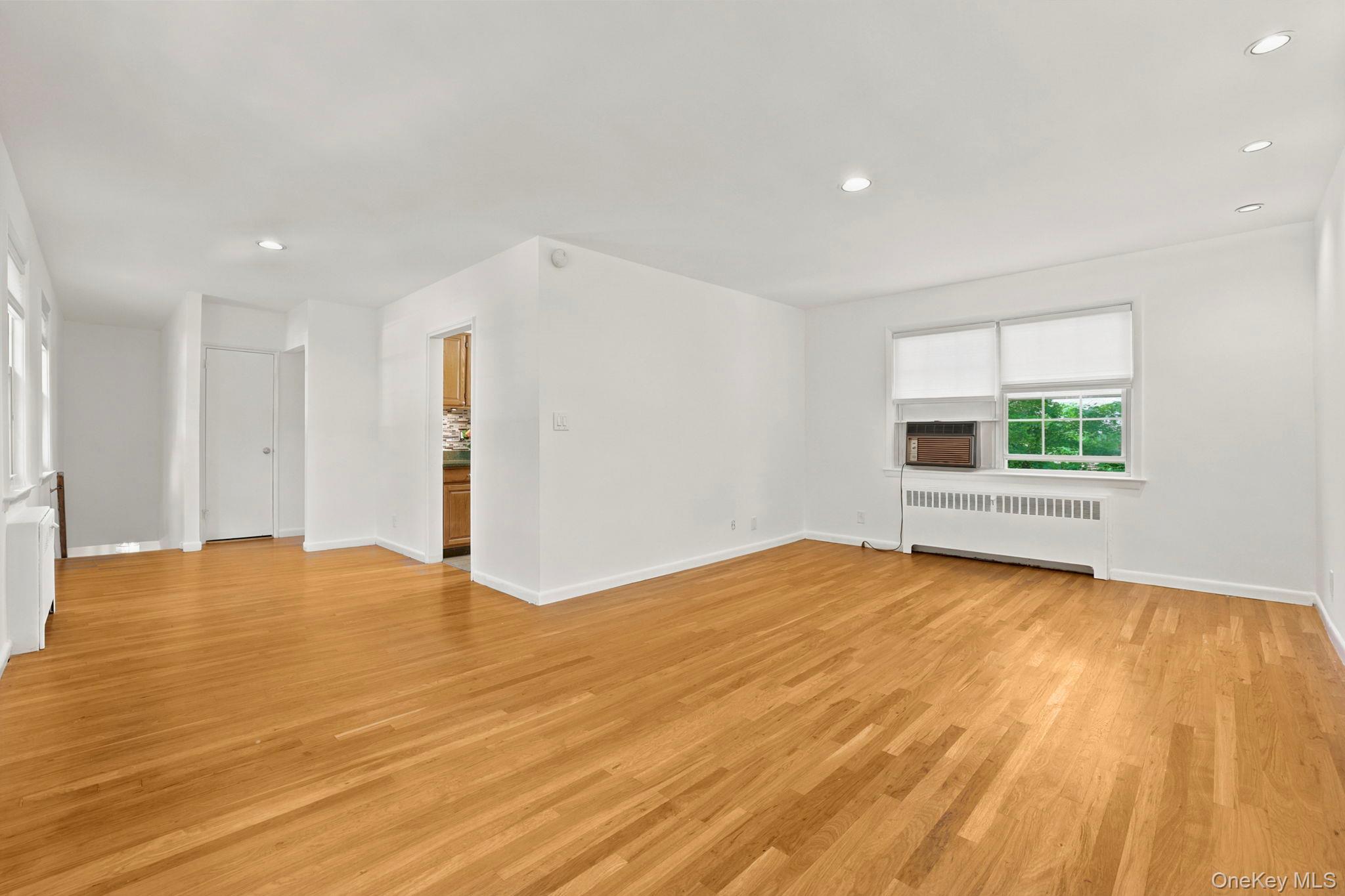 186 Pinewood Road, Unit 56 Hartsdale, NY 10530 - Photo 4 of 29 Expansive view of the living room and dining area with windows facing both north and south, allowing great ventilation