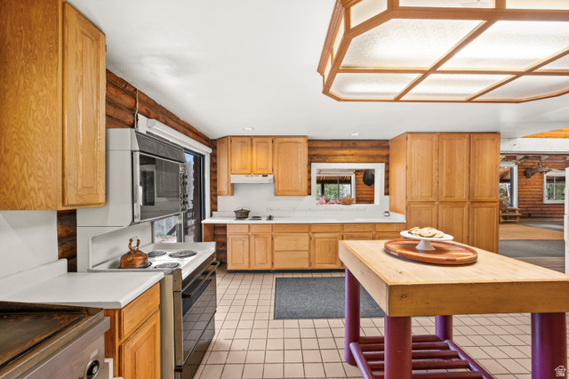 4725 Pine Ridge Road Evanston, UT 82930 - Photo 17 of 82 Kitchen featuring light wood cabinetry, white countertops, built-in oven, and a center island with a wood top