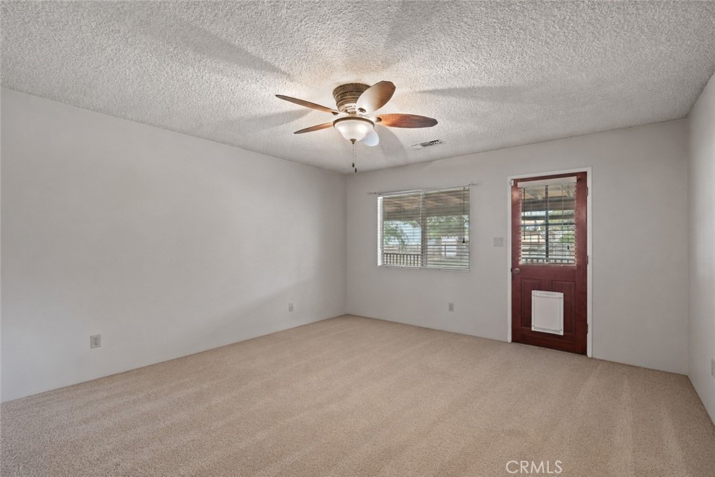 2065 Jenkins Road Bakersfield, CA 93314 - Photo 35 of 59 a view of an empty room with a ceiling fan and window