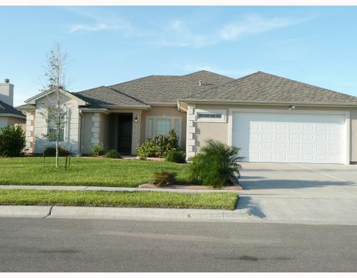 a front view of a house with a yard and a garage
