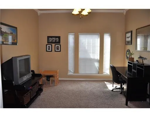 a living room with furniture wooden floor and a flat screen tv
