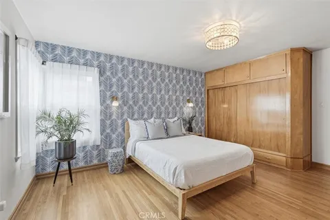 an empty room with wooden floor and closet