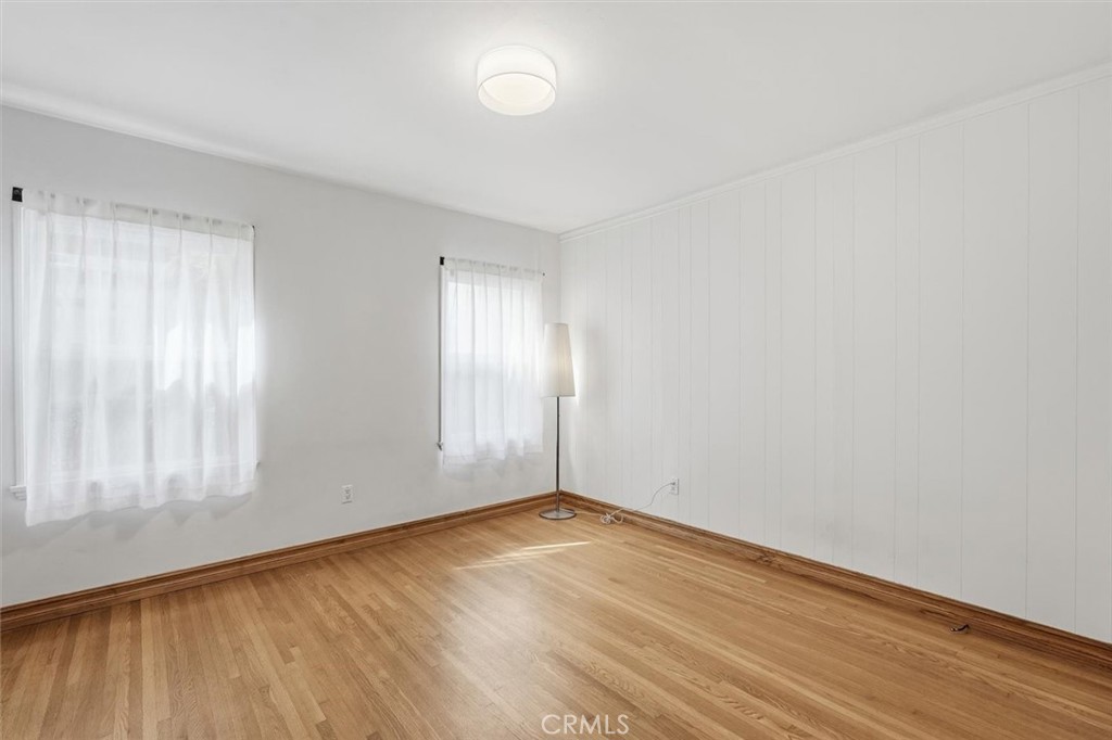 1424 Post Avenue Torrance, CA 90501 - Photo 24 of 34 an empty room with wooden floor and windows with curtains