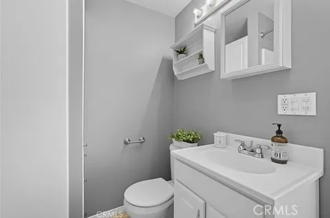 a balcony with potted plants and a bench