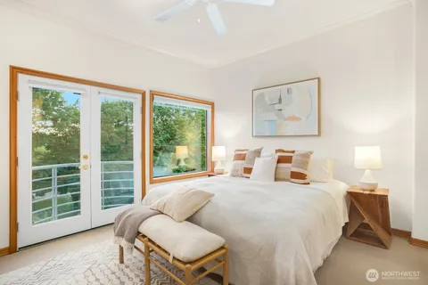 a spacious bedroom with a bed and a window