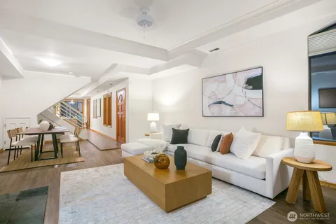 a living room with furniture and a painting on the wall