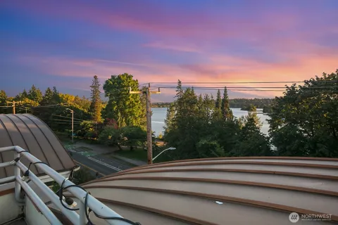 a kitchen with a sink a stove a kitchen island with chairs and wooden floor