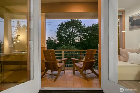 a view of balcony with wooden floor and outdoor seating
