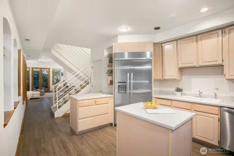 a living room with furniture a fireplace and a large window