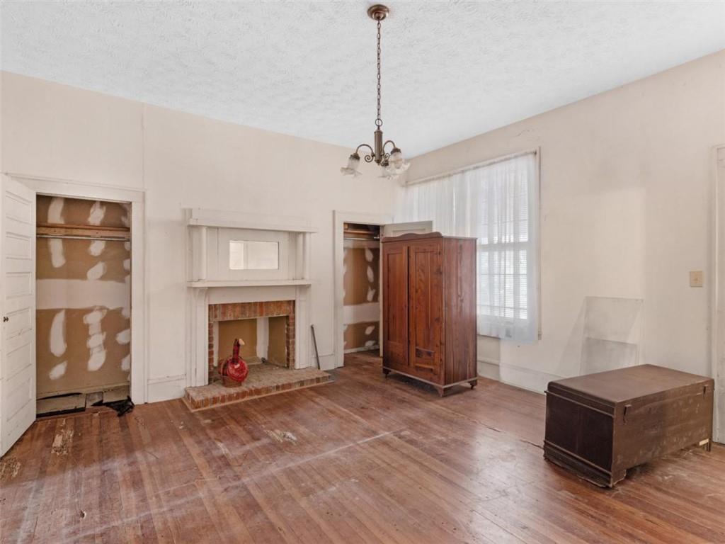 481 Turner Road Concord, GA 30206 - Photo 32 of 44 a living room with furniture a fireplace and a chandelier
