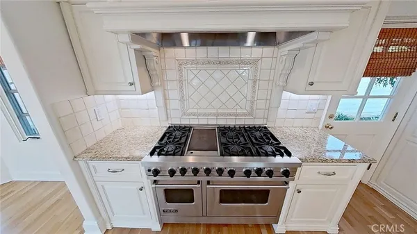 a stove top oven sitting inside of a kitchen