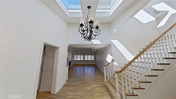 a view of hallway with stairs and wooden floor